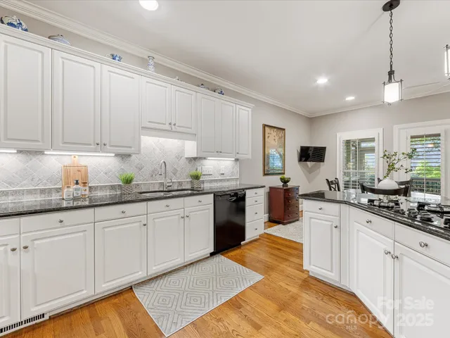 a dining room with stainless steel appliances kitchen island a table and chairs