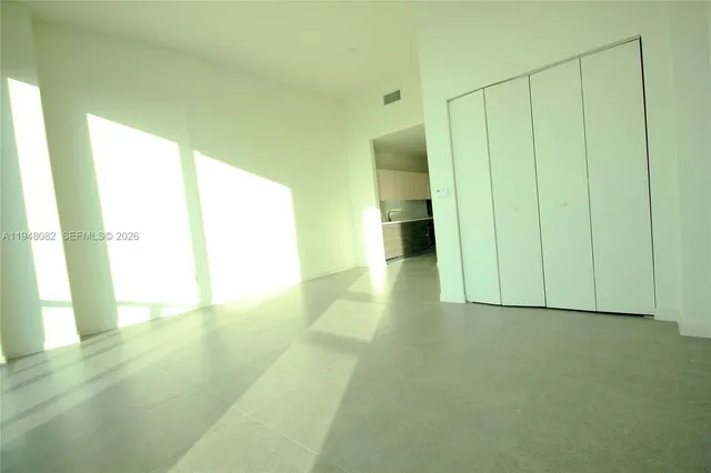 a view of a big room with sliding door and wooden floor