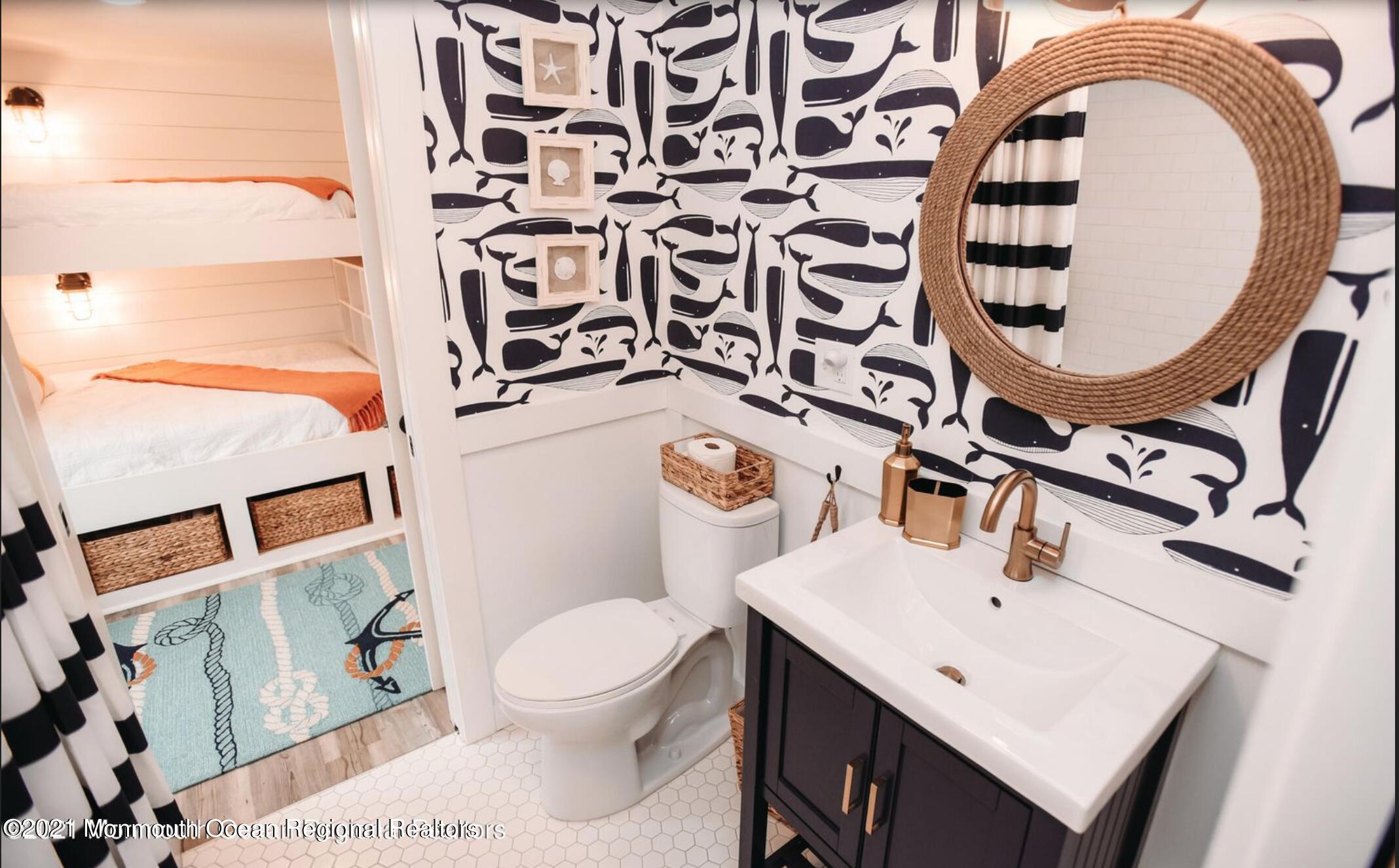 117 Boardwalk Point Pleasant Beach, NJ 08742 - Photo 13 of 24 a bathroom with a toilet a sink and a mirror