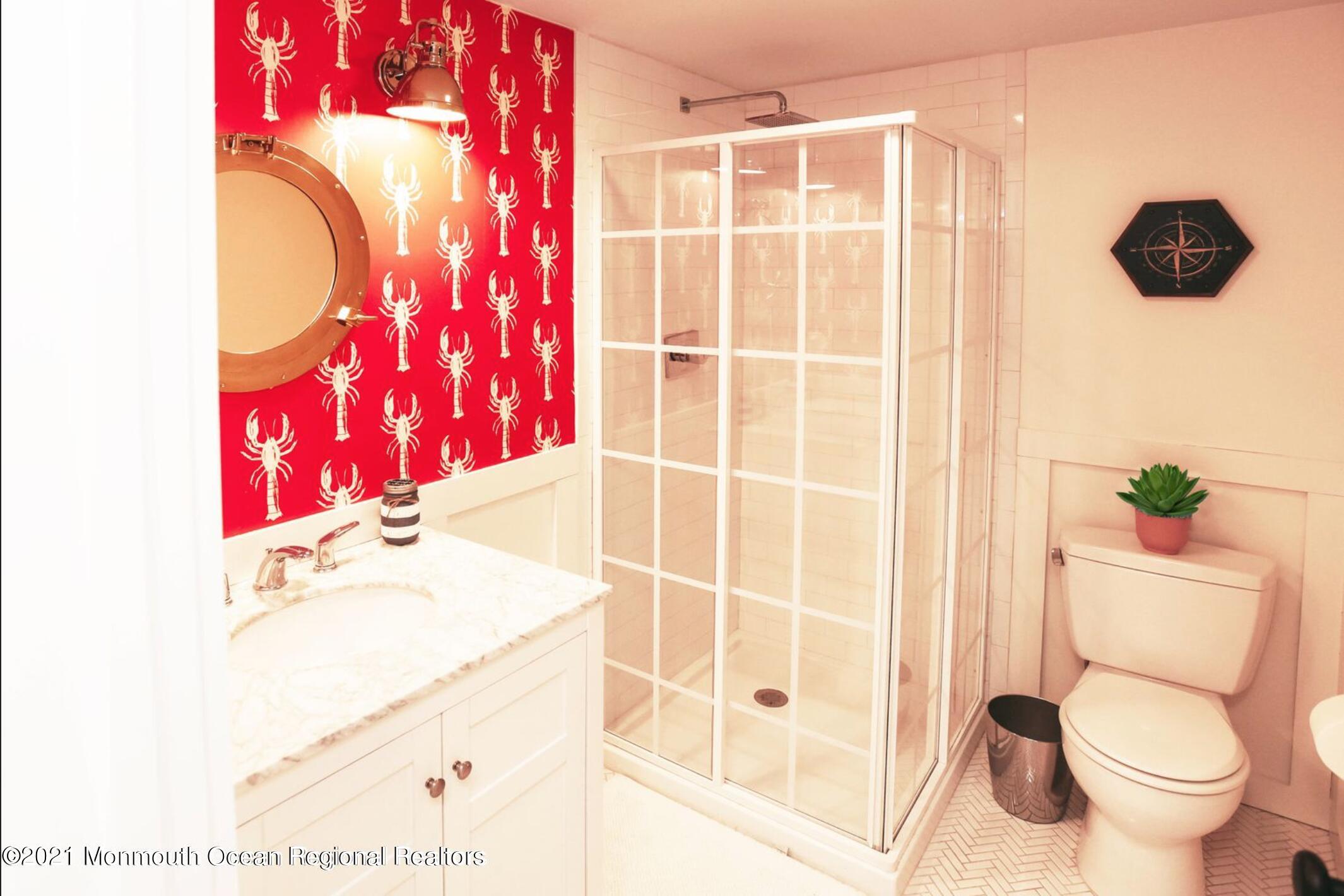 117 Boardwalk Point Pleasant Beach, NJ 08742 - Photo 15 of 24 a bathroom with a toilet and a shower curtain