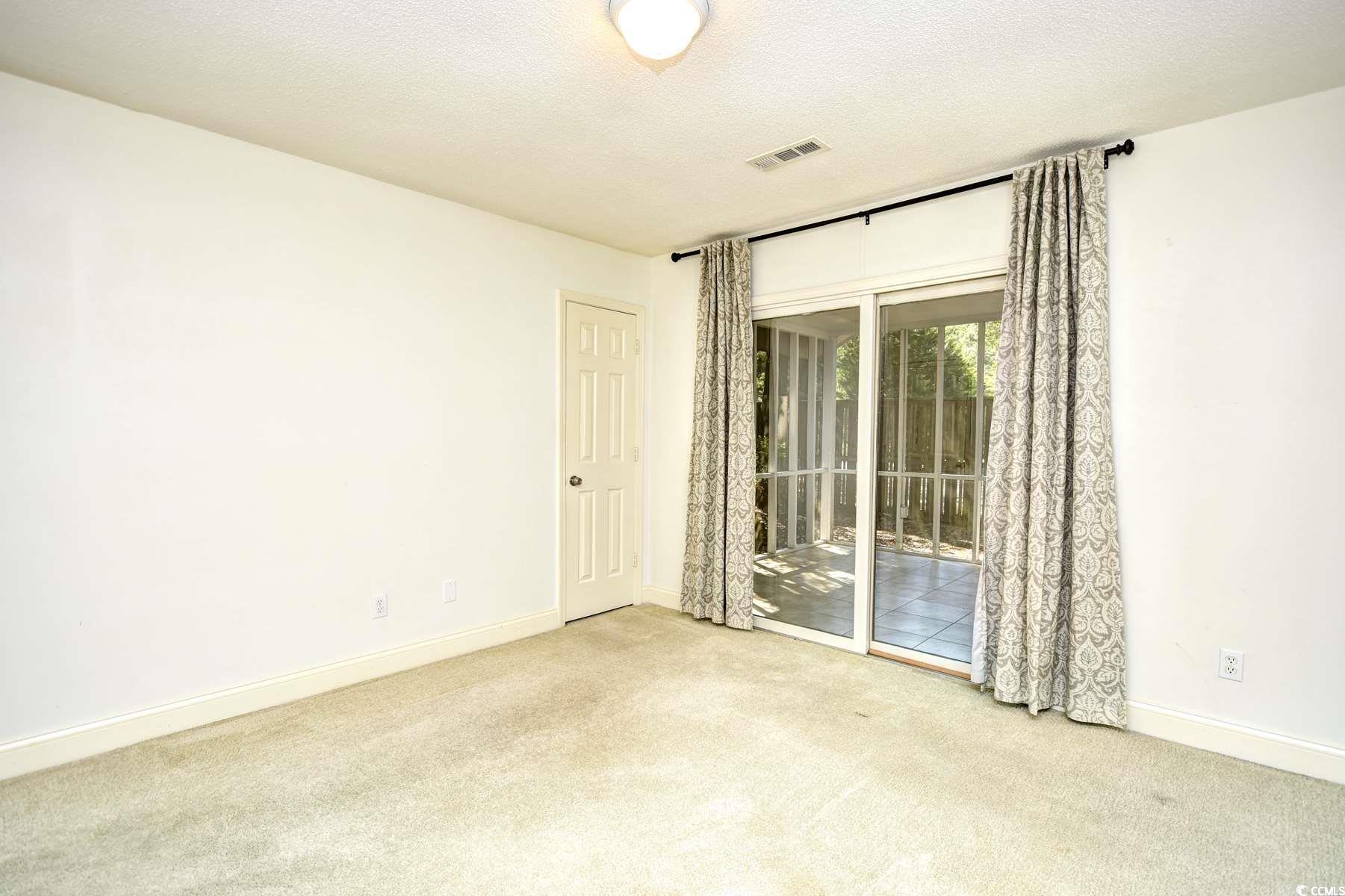 816 Kittiwake Lane Murrells Inlet, SC 29576 - Photo 14 of 25 Carpeted spare room with baseboards and visible ve