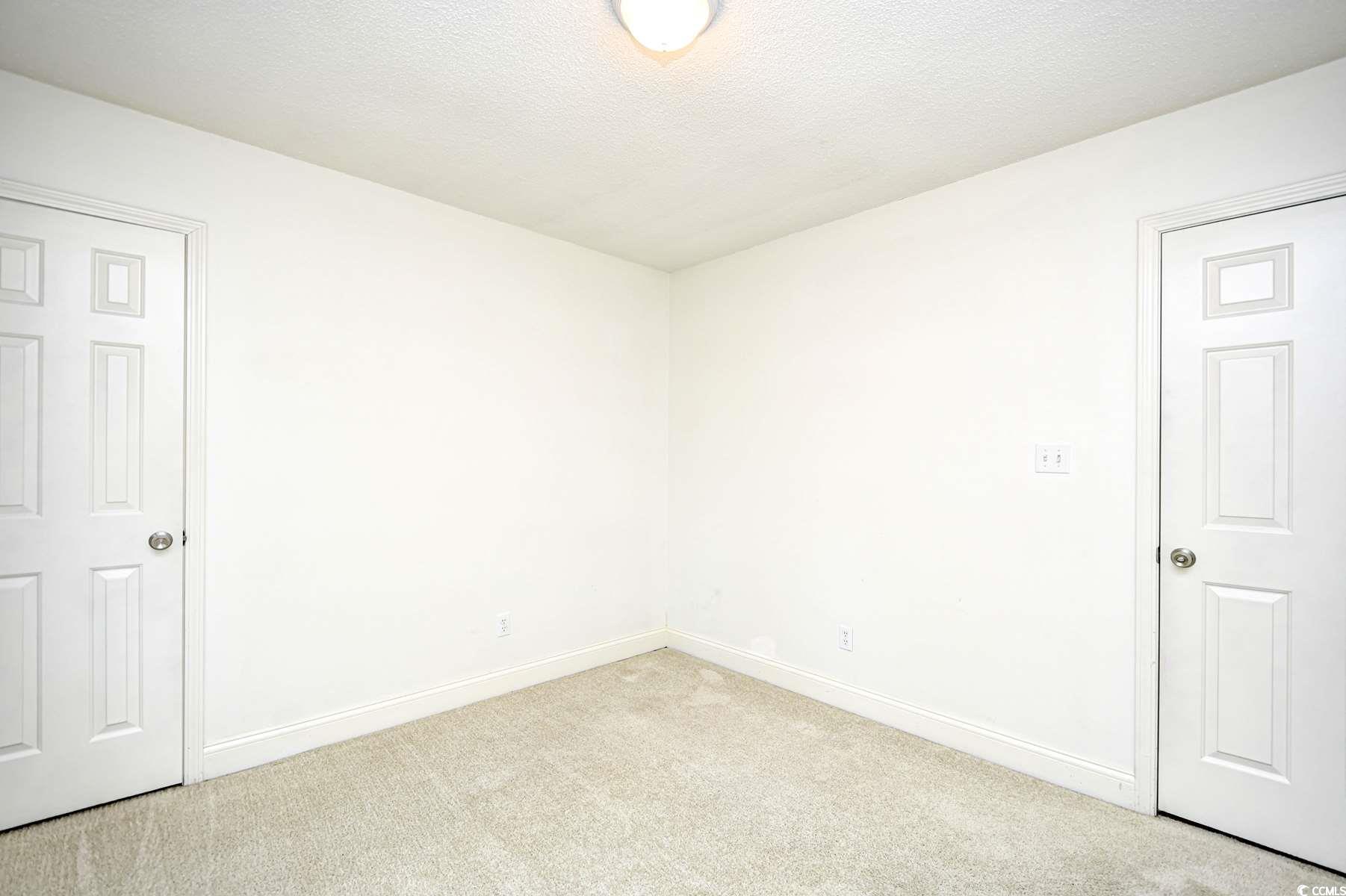 816 Kittiwake Lane Murrells Inlet, SC 29576 - Photo 19 of 25 Spare room with baseboards, a textured ceiling, an