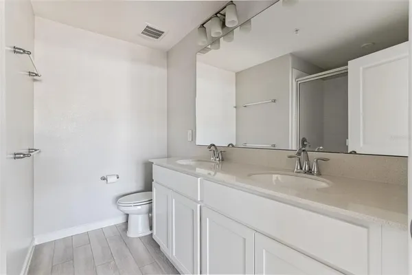 a bathroom with a toilet a sink and a mirror