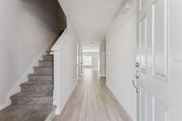 a view of a hallway with stairs