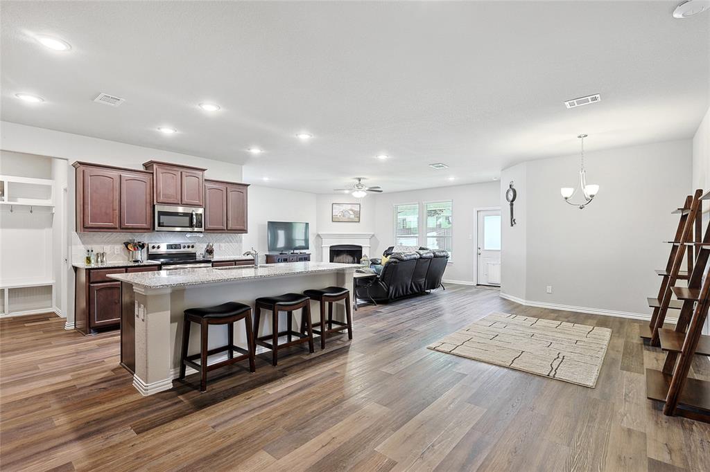 808 Feather Edge Drive Springtown, TX 76082 - Photo 11 of 40 a living room with stainless steel appliances granite countertop furniture wooden floor and a kitchen view