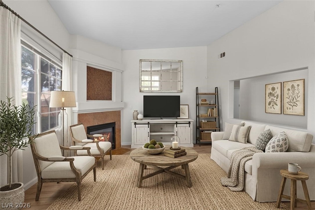 1881 West Alexander Road, Unit 1037 North Las Vegas, NV 89032 - Photo 3 of 31 VIRTUALLY STAGED -Natural light illuminates this living room, centered around a cozy fireplace and featuring high ceilings.