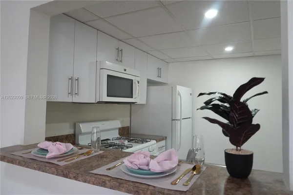 a kitchen with stainless steel appliances kitchen island granite countertop a sink and cabinets