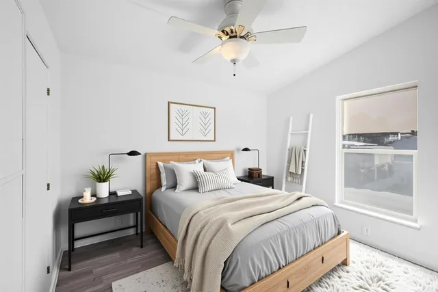 a bedroom with bed and window