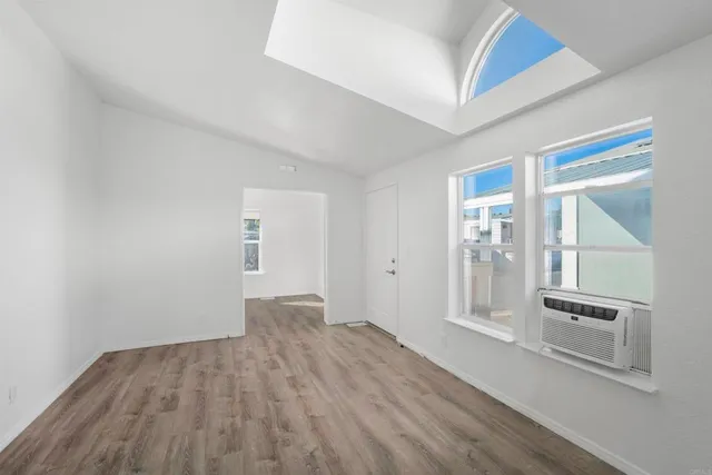 a view of wooden floor and windows in a room