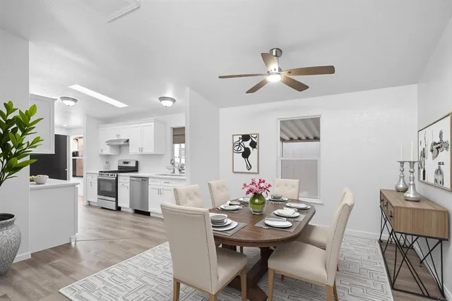 a view of a dining room with furniture and a kitchen