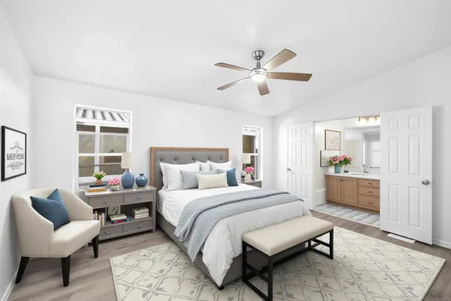 a bedroom with a bed couches and a window