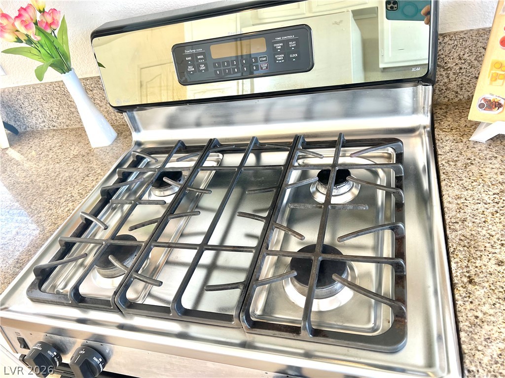 9708 Ridge Creek Place Las Vegas, NV 89134 - Photo 12 of 34 Culinary adventures await on this immaculate stainless steel range with easy-to-clean gas cooktop.