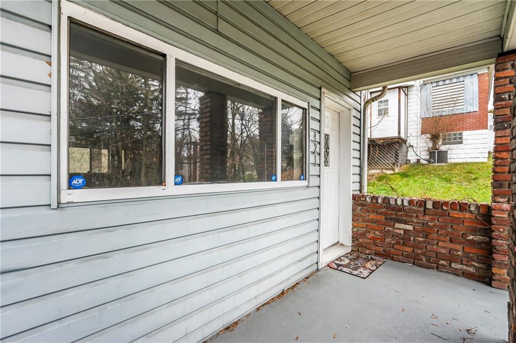 421 High Street McKeesport, PA 15132 - Photo 4 of 23 a view of a porch with wooden floor and floor to ceiling window