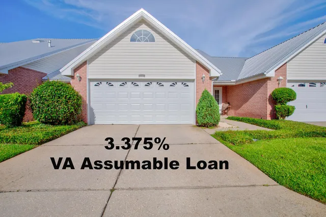 a front of a house with a sign board
