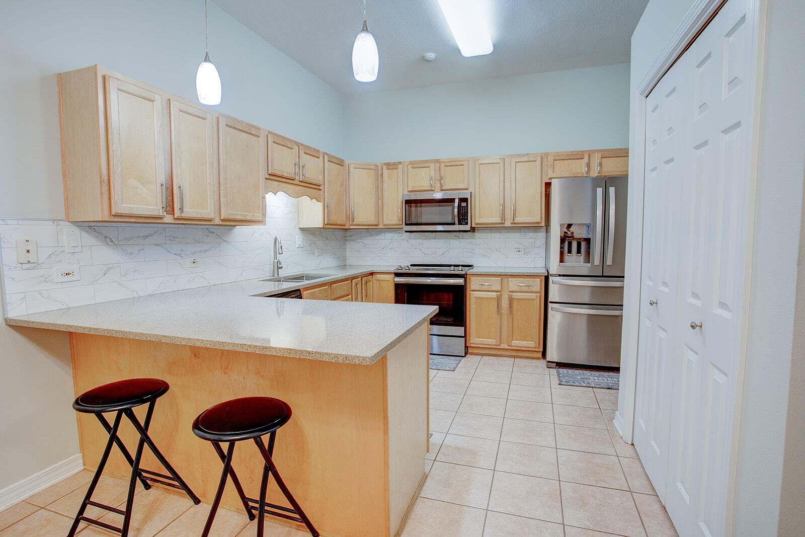 1956 Woodcrest Ridge Fort Walton Beach, FL 32547 - Photo 13 of 31 a kitchen with stainless steel appliances kitchen island a refrigerator sink and cabinets