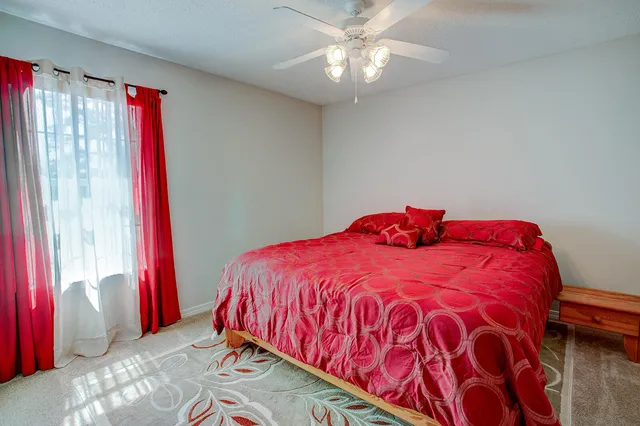 a bedroom with a bed and a lamp