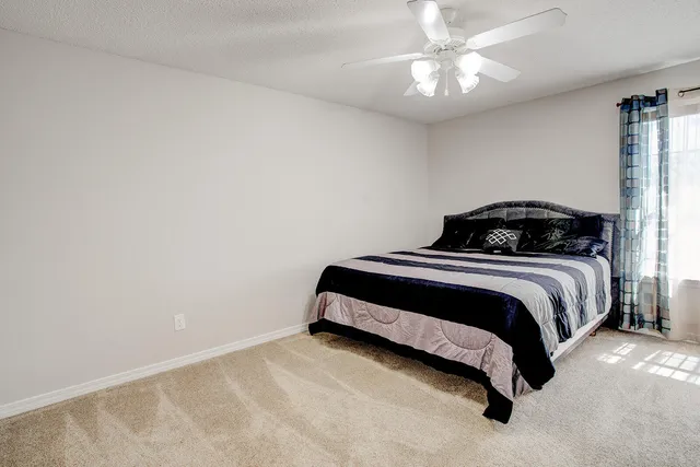 a bedroom with a bed and window