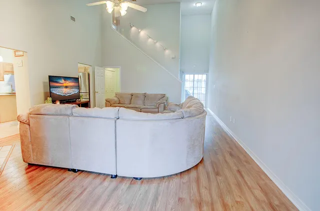 a living room with furniture and a chandelier