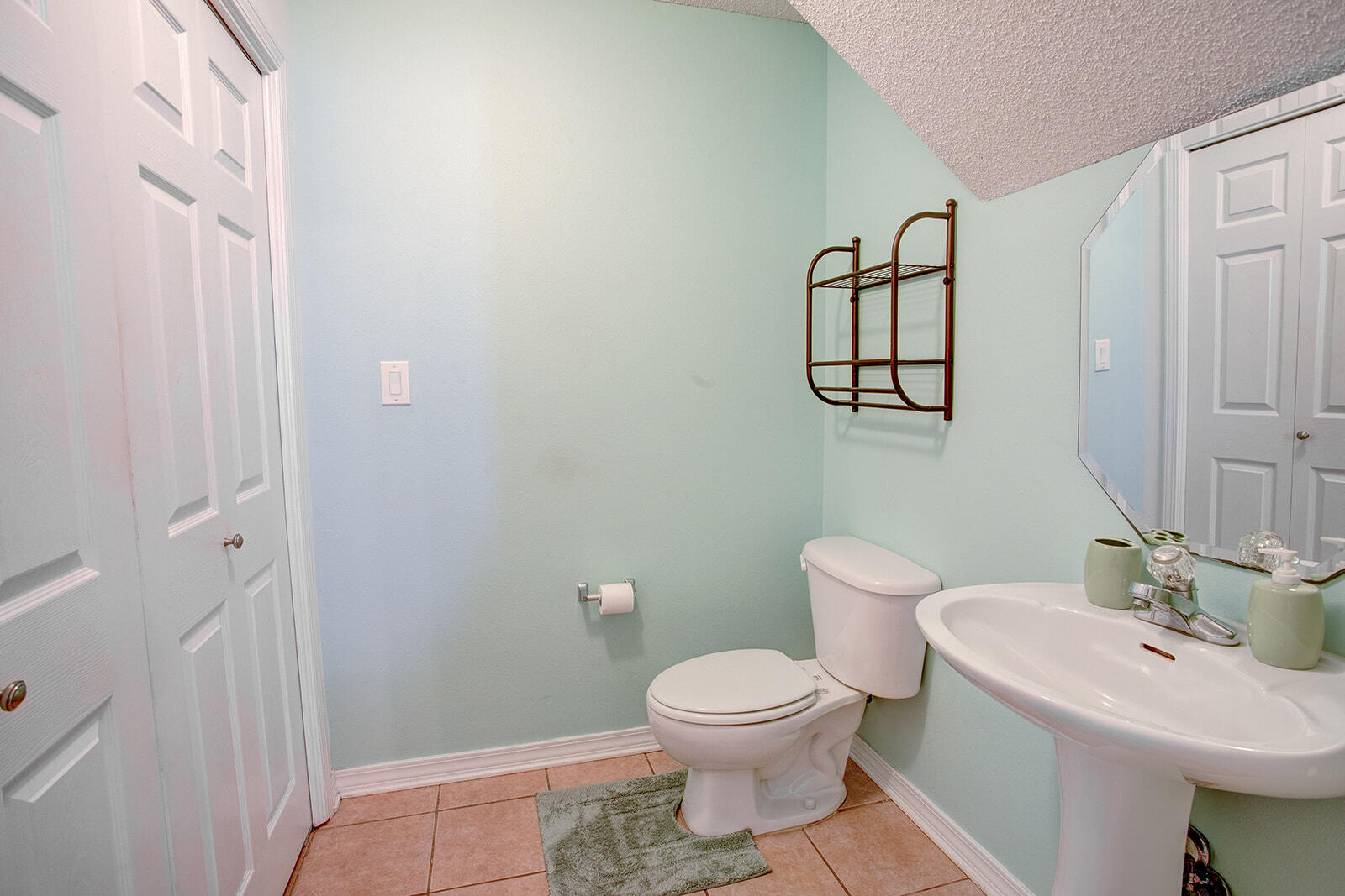 1956 Woodcrest Ridge Fort Walton Beach, FL 32547 - Photo 6 of 31 a bathroom with a toilet a sink and mirror