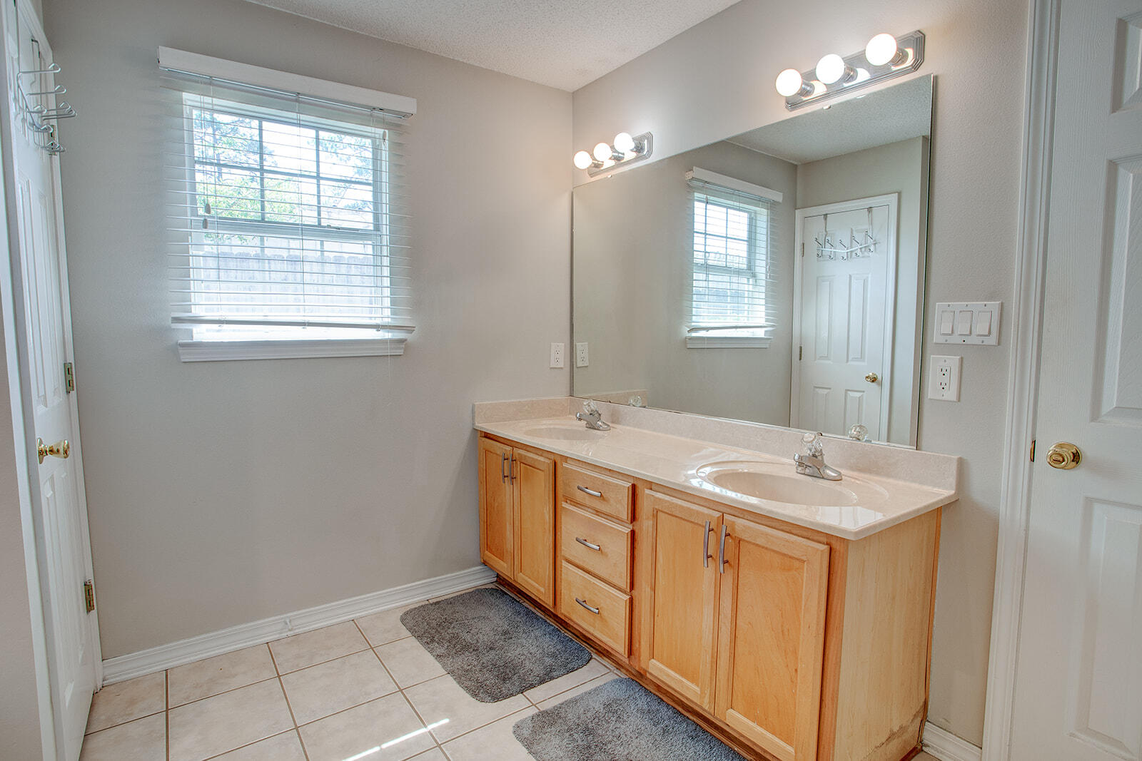 1956 Woodcrest Ridge Fort Walton Beach, FL 32547 - Photo 9 of 31 a bathroom with a granite countertop sink and a mirror