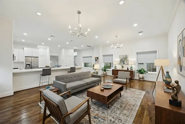 a living room with furniture and kitchen view