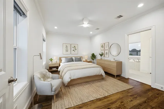 a bedroom with a large bed and a chandelier