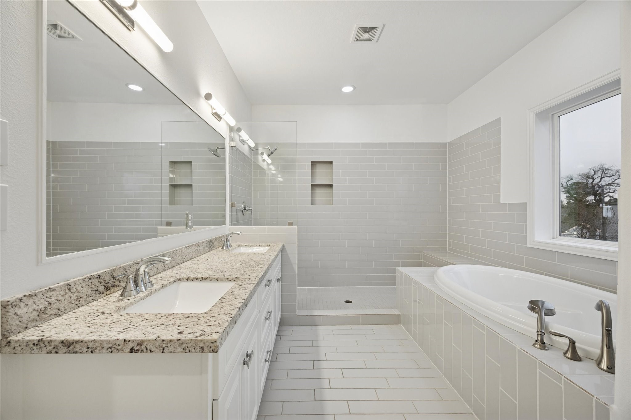 1630 West 24th Street Houston, TX 77008 - Photo 7 of 24 primary bath, porcelain tile, built in cubbies.