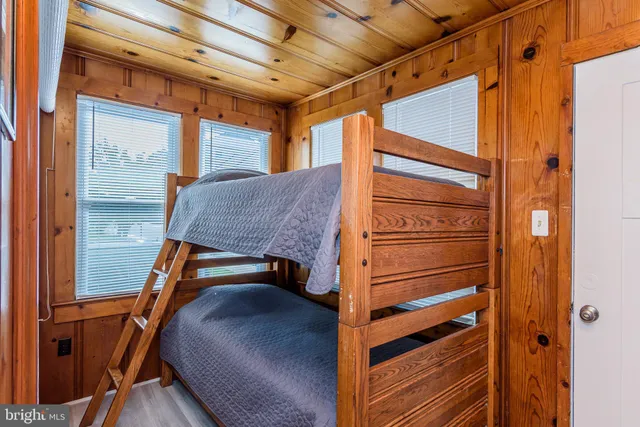a dining room with furniture a chandelier and wooden floor
