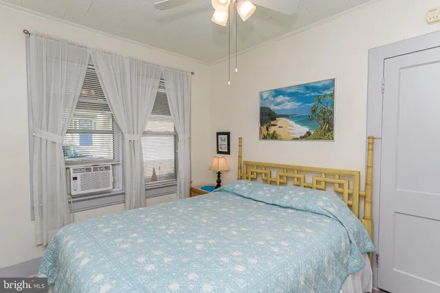 a bedroom with a bed and hallway