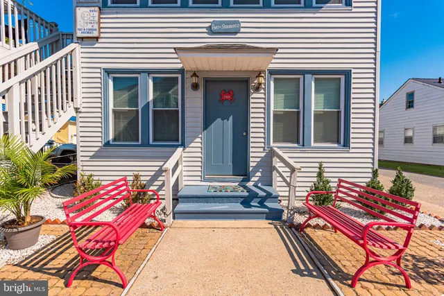 a view of a patio with couches chairs and wooden floor