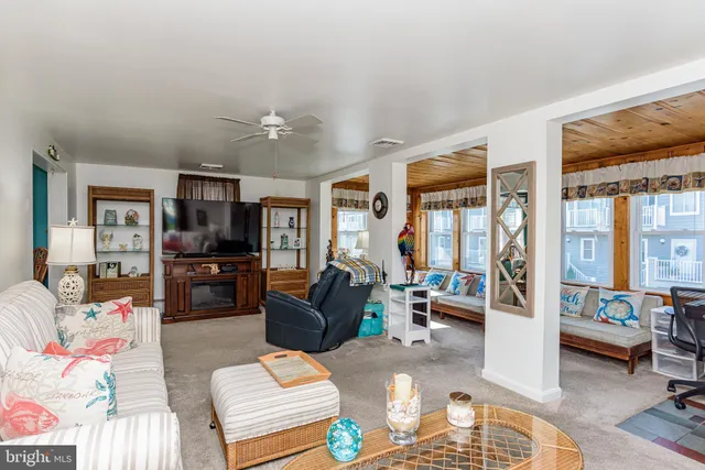 a dining room with furniture a rug and wooden floor