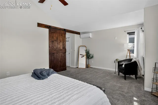 a bedroom with a bed and a chair