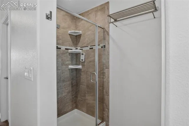 a bathroom with a glass shower door