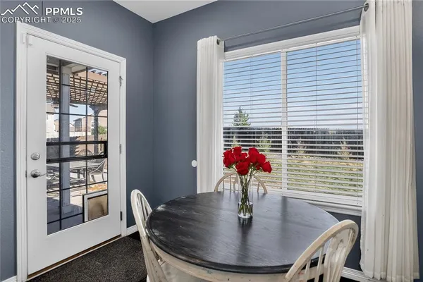 a dining room with furniture and window