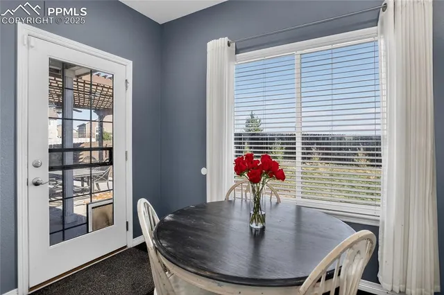 a dining room with furniture and window