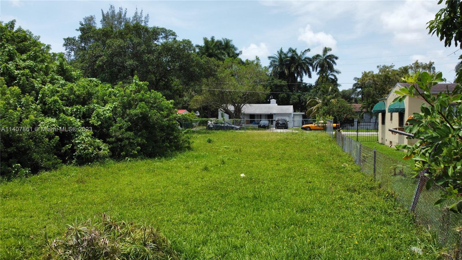 75 Northwest 85th Street Miami, FL 33150 - Photo 4 of 10 a backyard of a house with table and chairs
