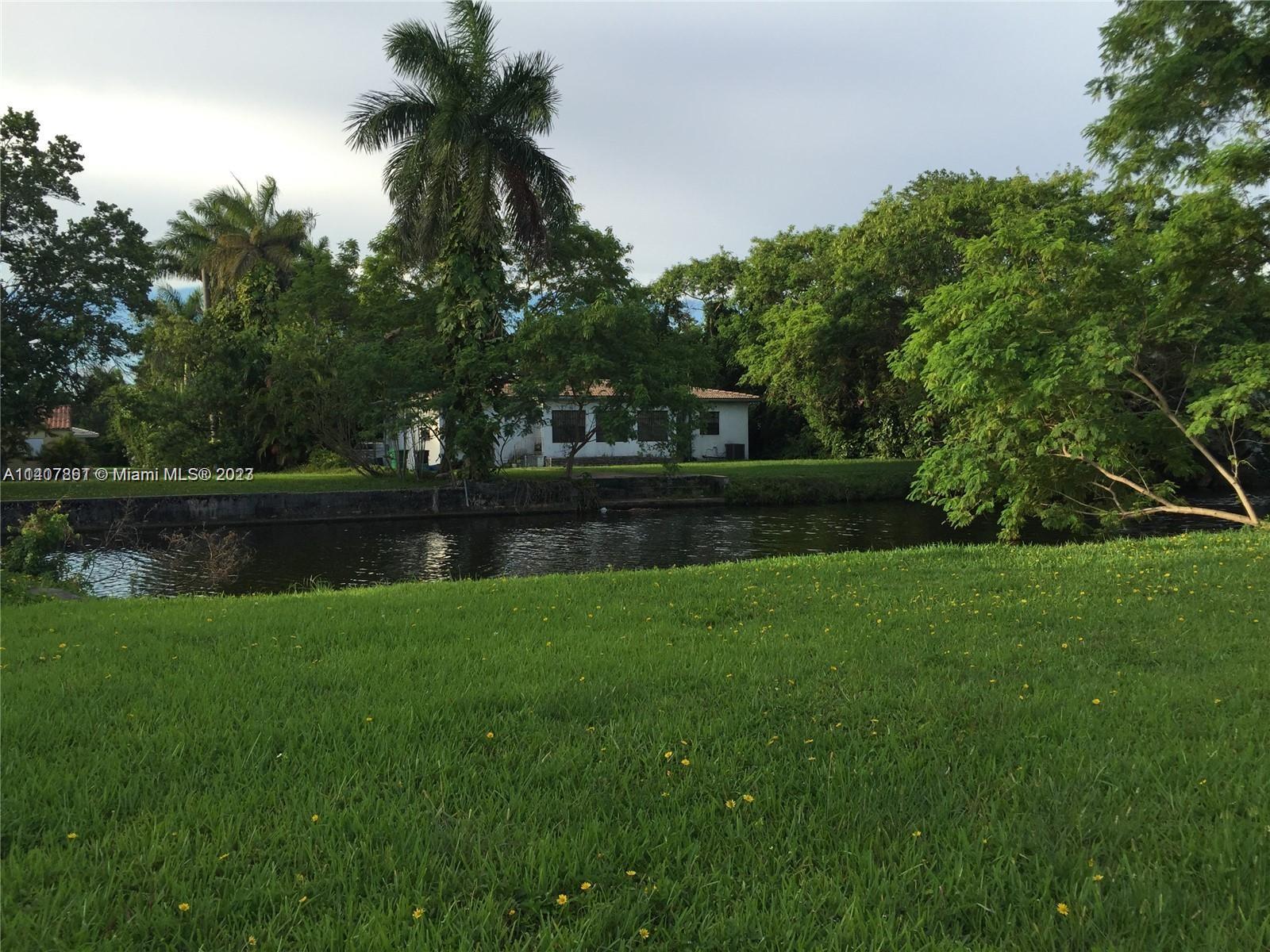 75 Northwest 85th Street Miami, FL 33150 - Photo 5 of 10 a view of a garden and lake