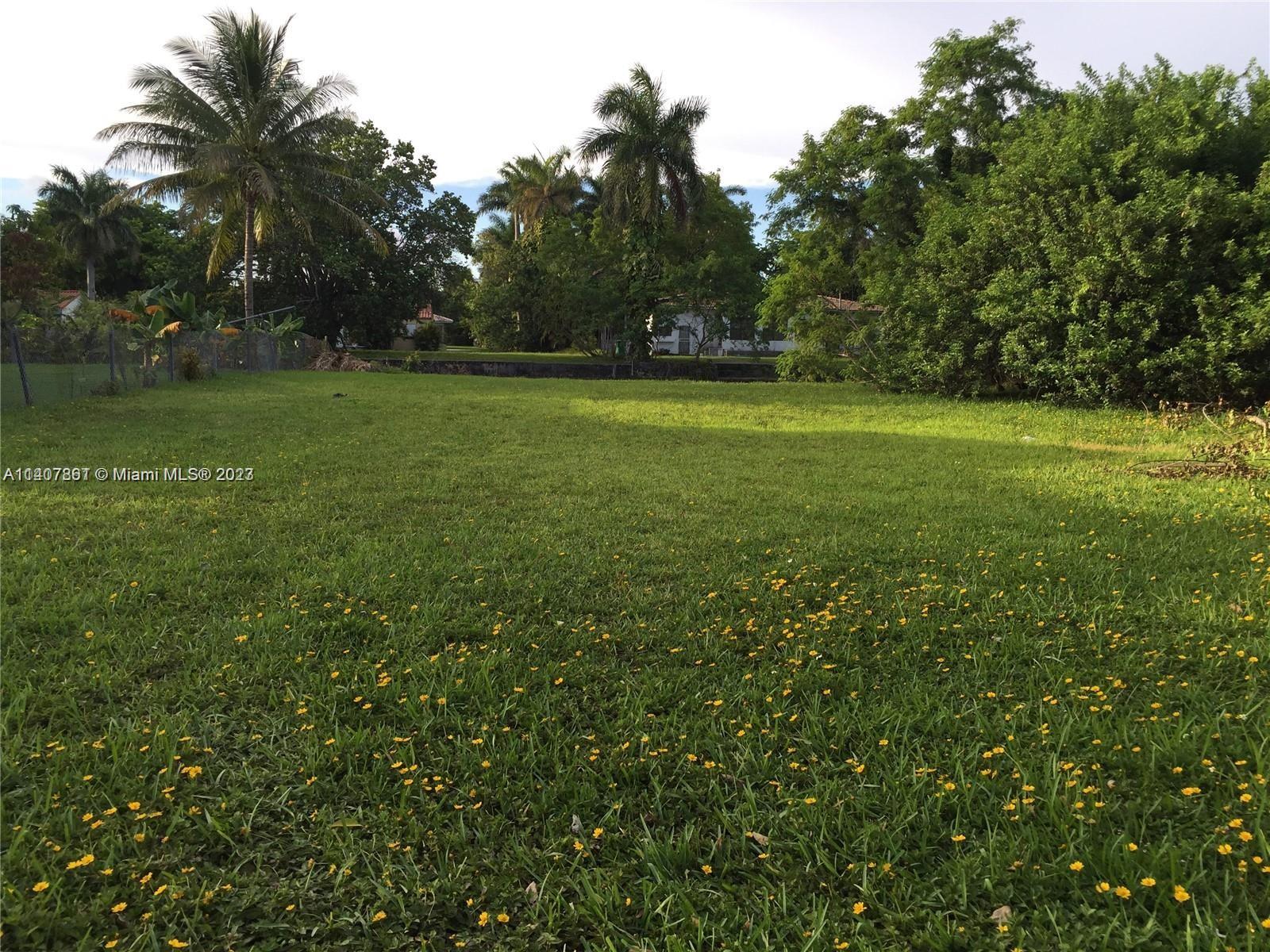 75 Northwest 85th Street Miami, FL 33150 - Photo 6 of 10 a view of outdoor space with green field and trees