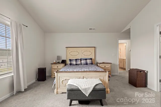 a room with a table chairs and a refrigerator