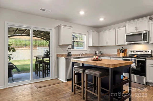 a kitchen with a stove a sink and a refrigerator