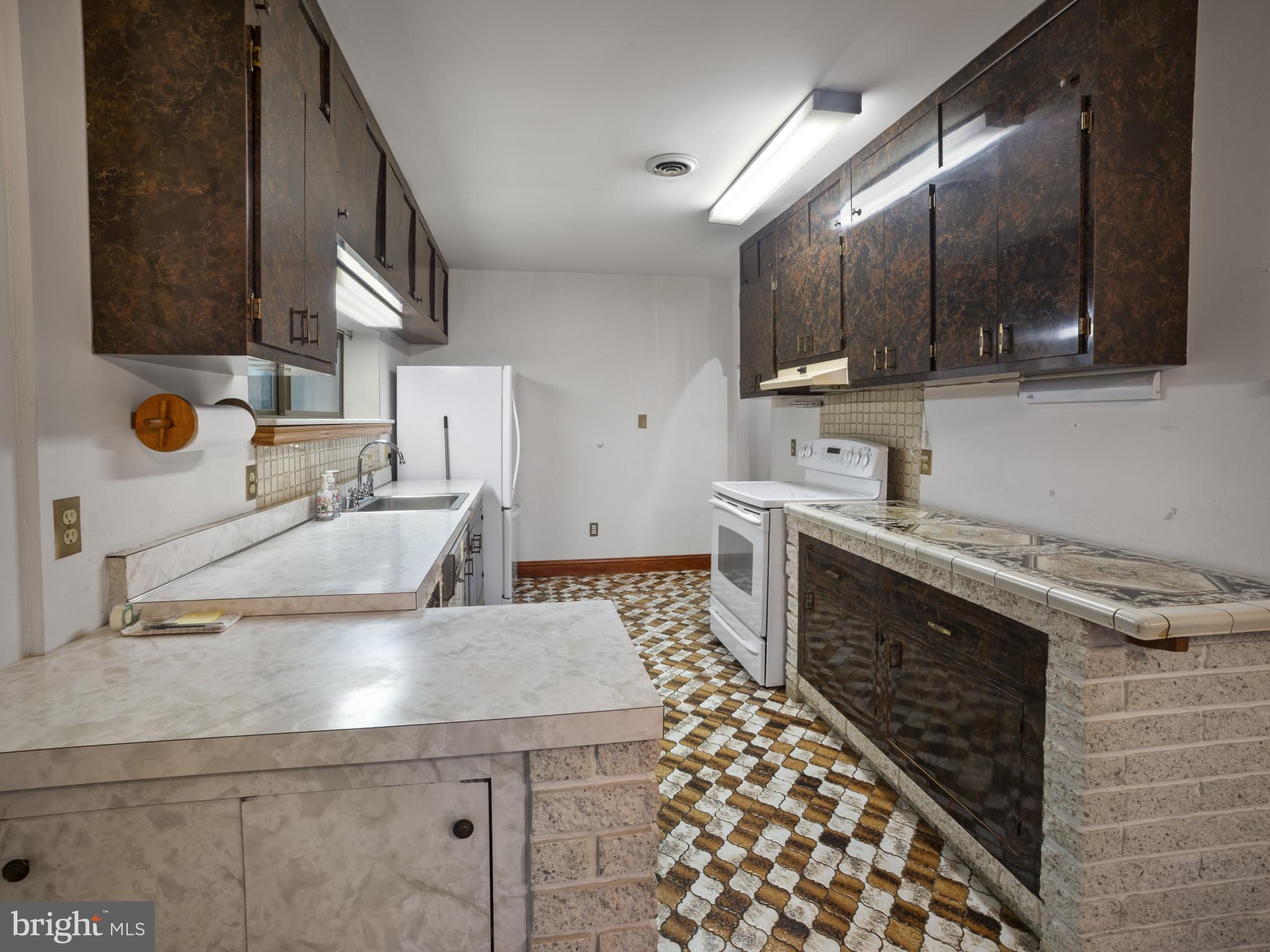 372 Sansbury Road Friendship, MD 20758 - Photo 10 of 33 a kitchen with a sink and a stove top oven