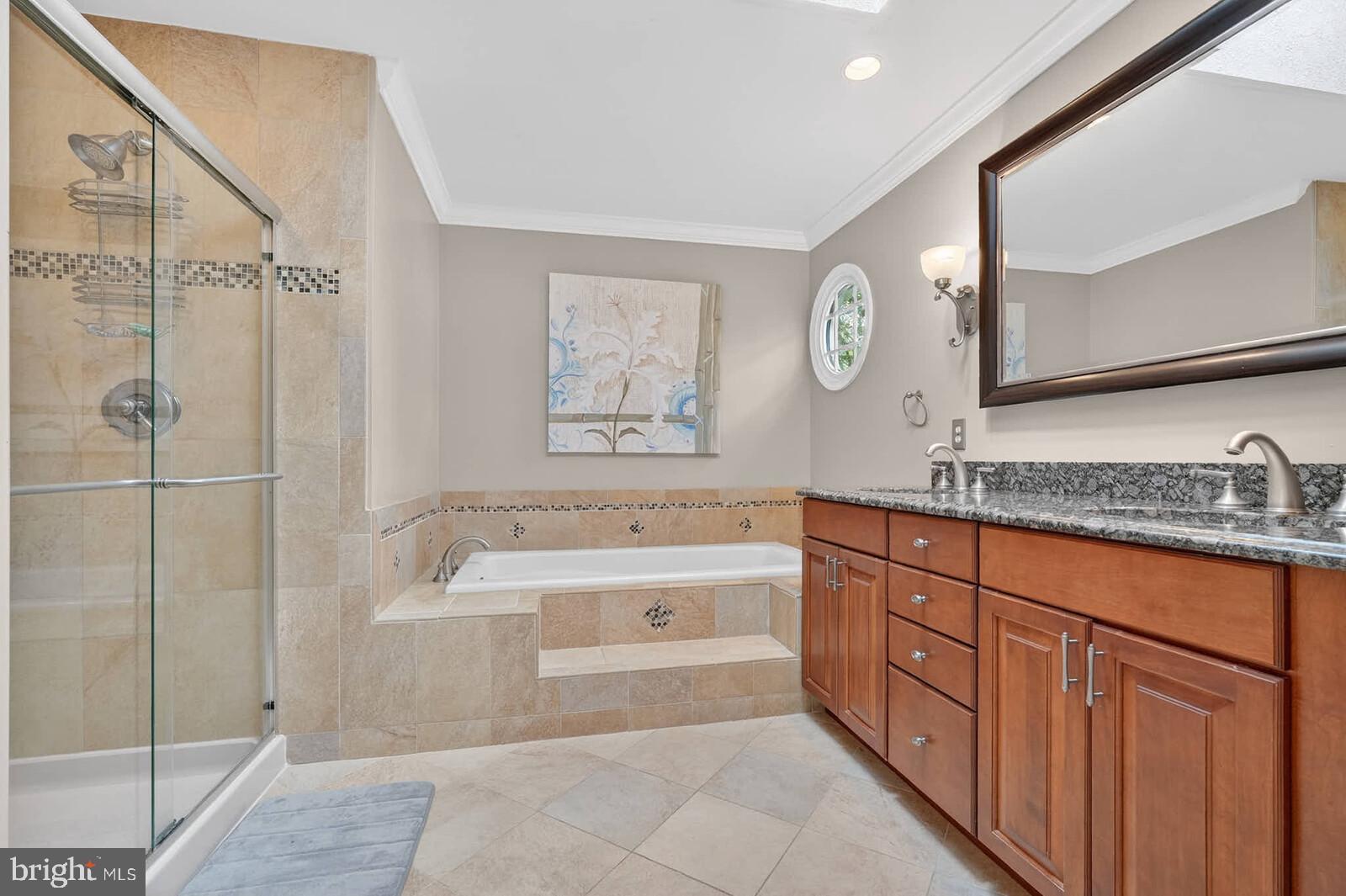2108 Merrifields Drive Silver Spring, MD 20906 - Photo 28 of 69 a spacious bathroom with a granite countertop sink a mirror a bathtub and shower