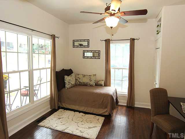 609 Latta Street Raleigh, NC 27607 - Photo 11 of 13 a bedroom with a bed and a window