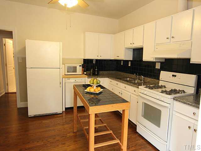 609 Latta Street Raleigh, NC 27607 - Photo 5 of 13 a kitchen with a stove a sink and a refrigerator