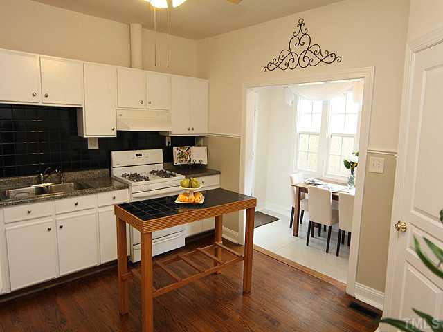 609 Latta Street Raleigh, NC 27607 - Photo 6 of 13 a kitchen with stainless steel appliances a stove a sink a refrigerator and cabinets