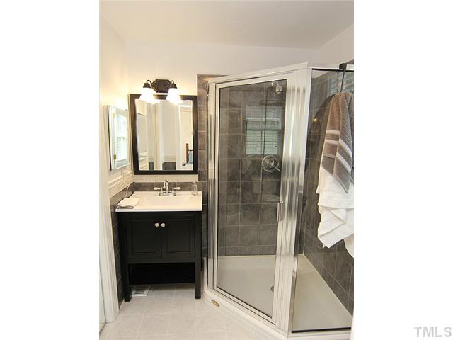 609 Latta Street Raleigh, NC 27607 - Photo 9 of 13 a bathroom with a sink and mirror