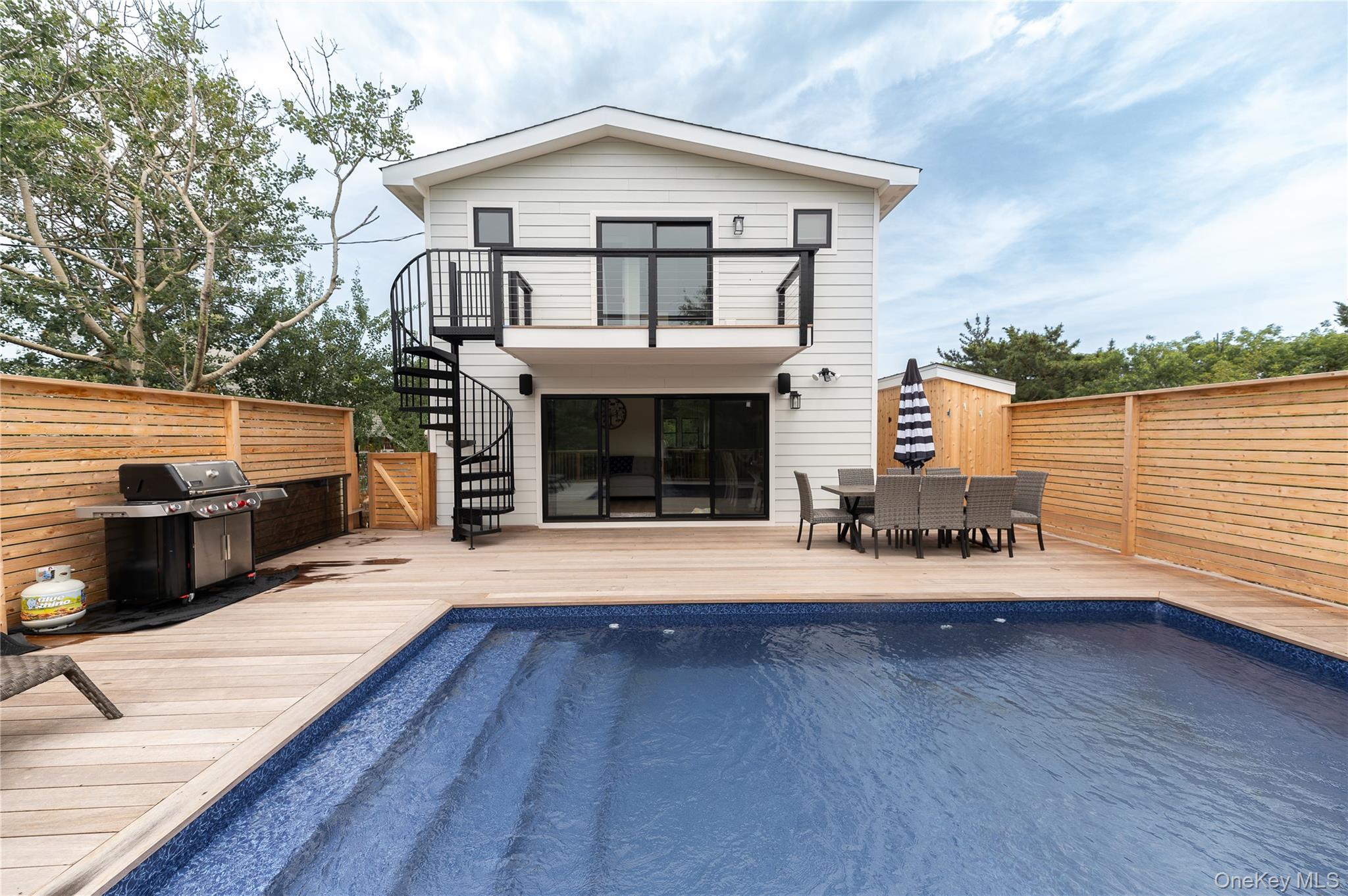 108 Ocean Road Ocean Beach, NY 11770 - Photo 1 of 23 Back of house featuring stairway, outdoor dining space, a deck, and a balcony