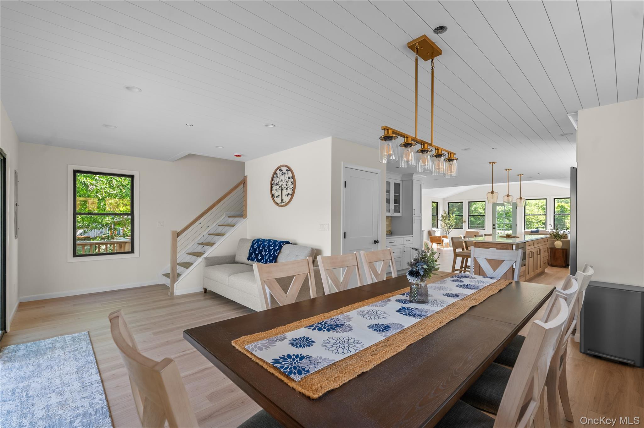 108 Ocean Road Ocean Beach, NY 11770 - Photo 10 of 23 Dining area featuring light wood-style floors, stairs, and wooden ceiling