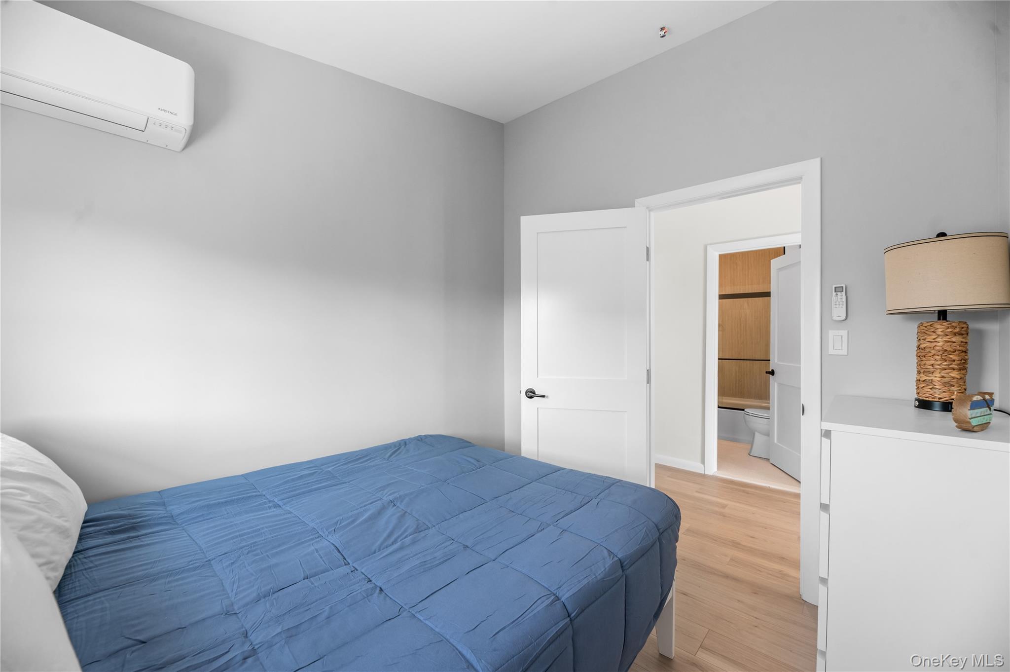 108 Ocean Road Ocean Beach, NY 11770 - Photo 15 of 23 Bedroom with a wall mounted air conditioner and light wood-style floors