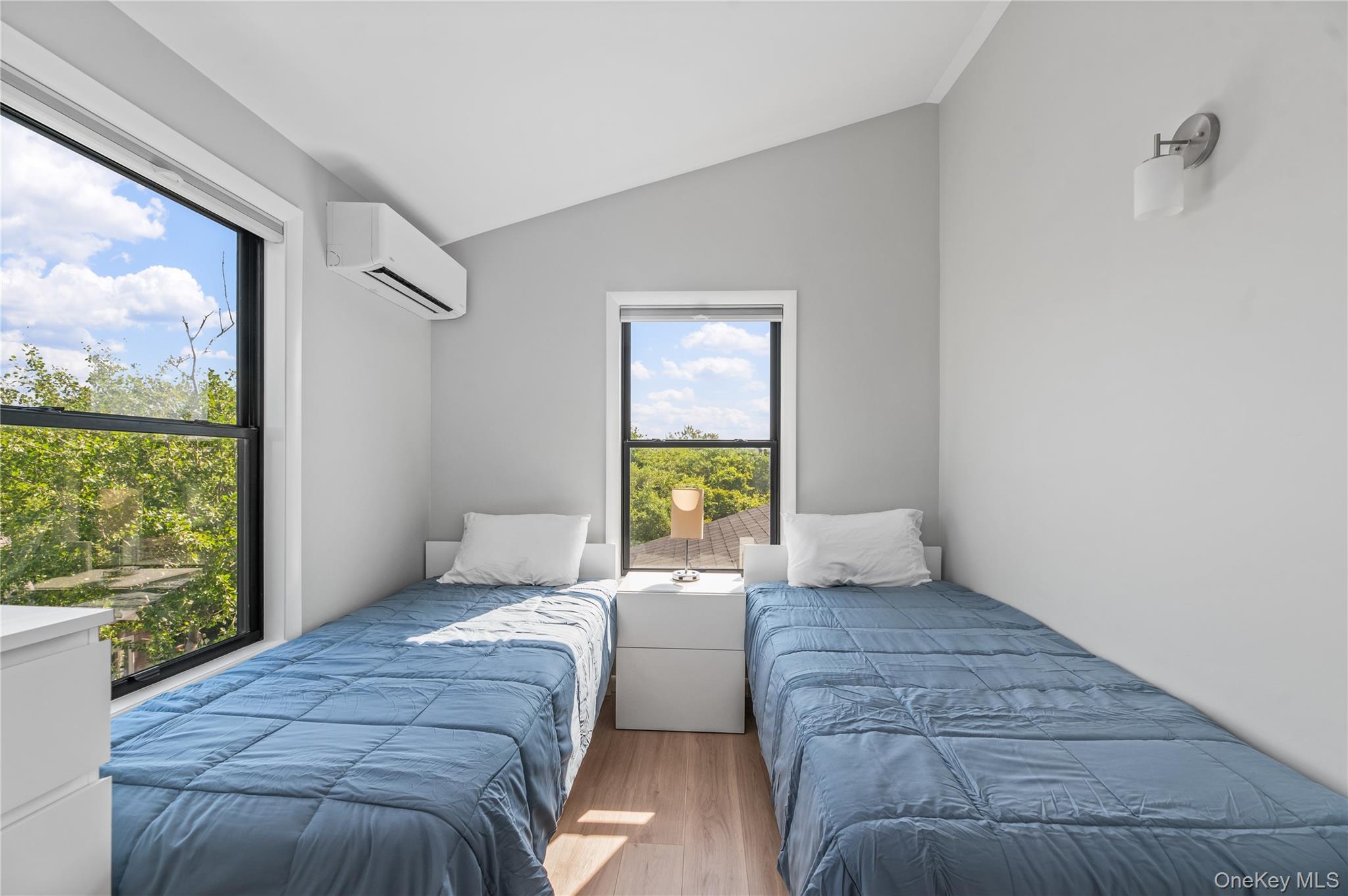 108 Ocean Road Ocean Beach, NY 11770 - Photo 18 of 23 Bedroom featuring vaulted ceiling, wood finished floors, and a wall mounted AC